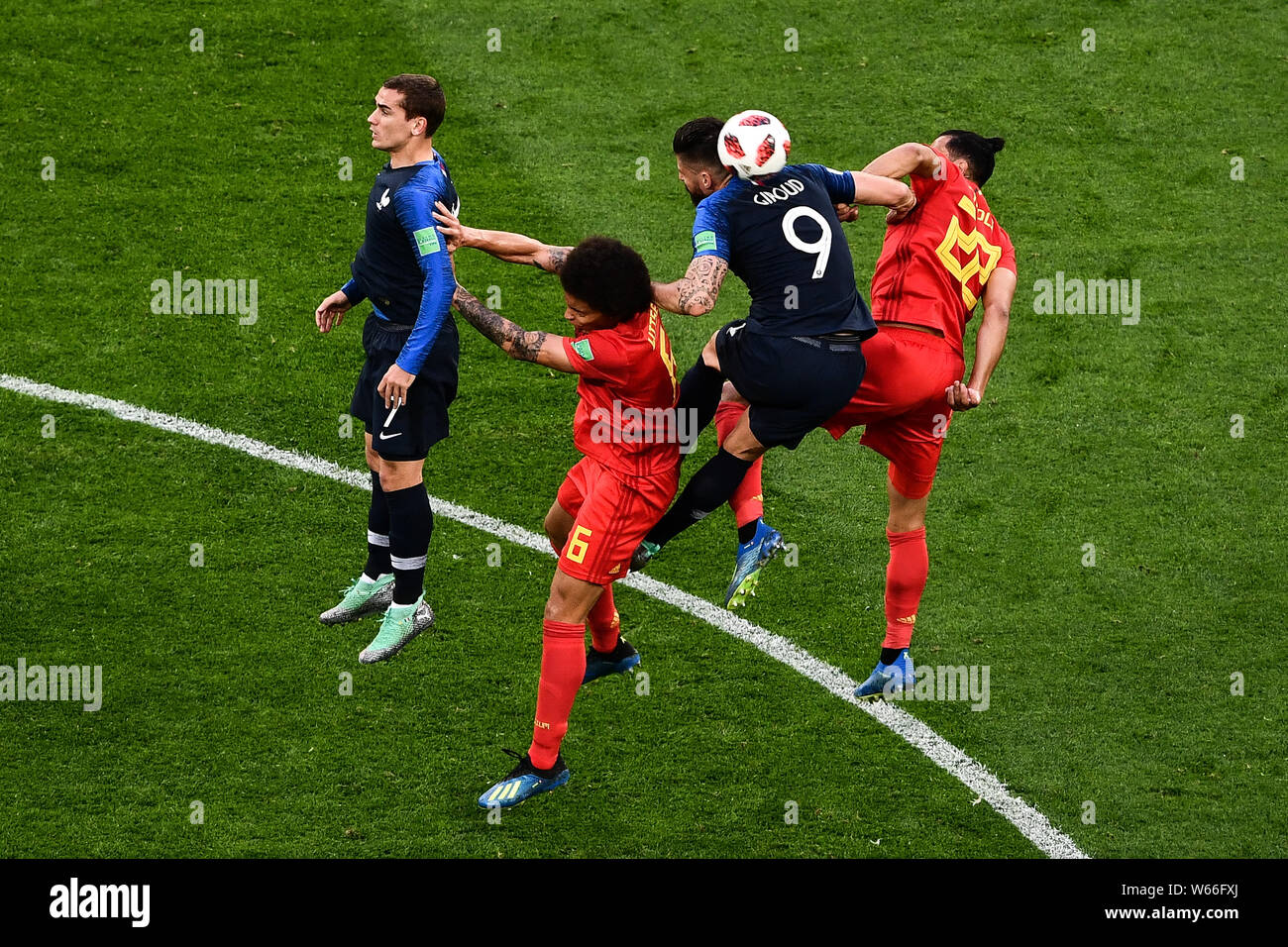 Nacer Chadli, right, and Axel Witsel, second left, of Belgium challenge Antoine Griezmann, left, and Olivier Giroud of France in their semifinal match Stock Photo
