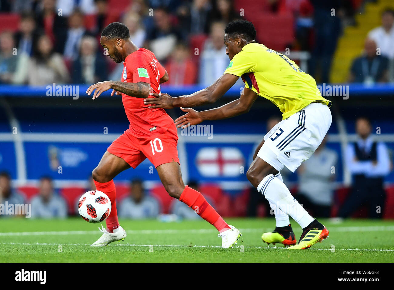 Yerry Mina of Columbia, right, challenges Raheem Sterling of England in their Round of 16 match during the 2018 FIFA World Cup in Moscow, Russia, 3 Ju Stock Photo