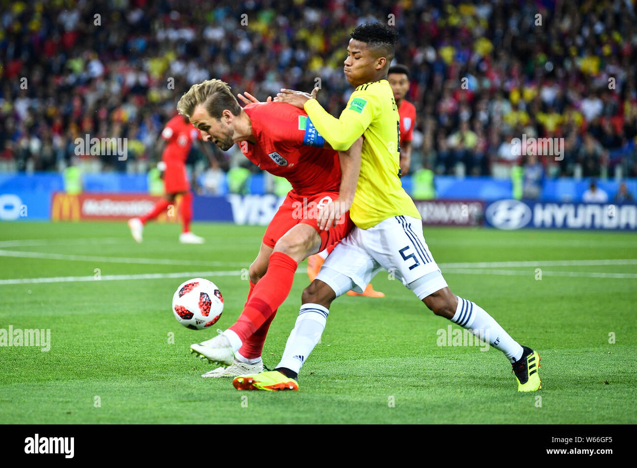 Jordan Henderson of England, left, challenges Wilmar Barrios of Columbia in their Round of 16 match during the 2018 FIFA World Cup in Moscow, Russia, Stock Photo