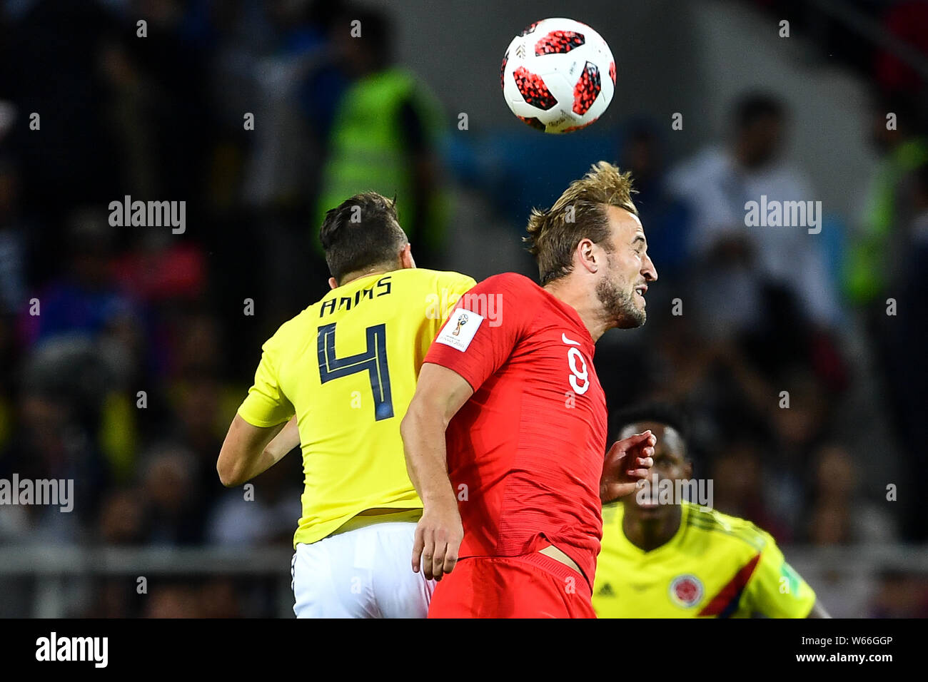 Harry Kane of England, right, heads the ball against Santiago Arias of Columbia in their Round of 16 match during the 2018 FIFA World Cup in Moscow, R Stock Photo