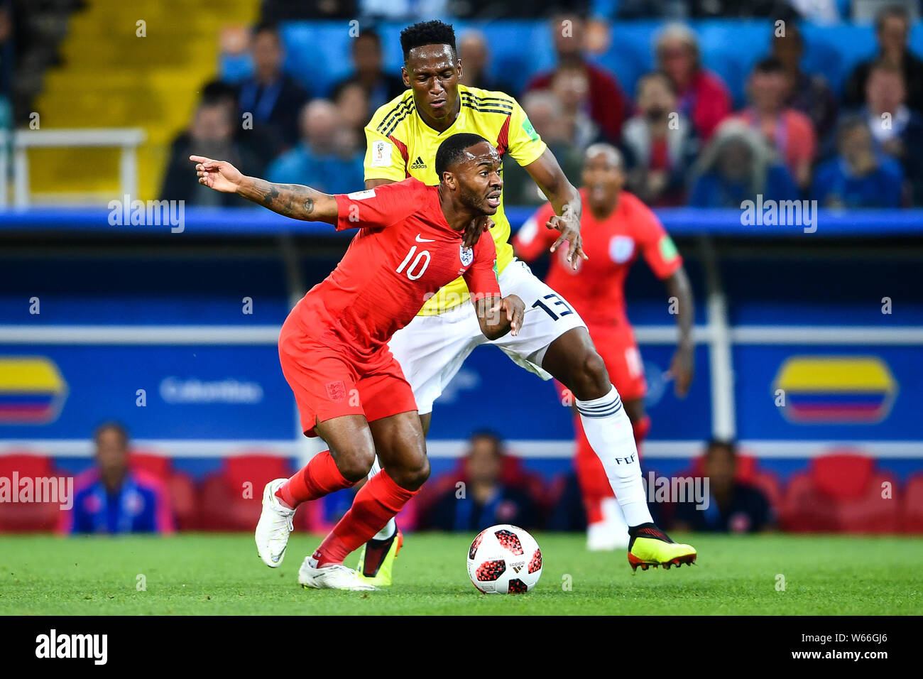 Yerry Mina of Columbia, back, challenges Raheem Sterling of England in their Round of 16 match during the 2018 FIFA World Cup in Moscow, Russia, 3 Jul Stock Photo