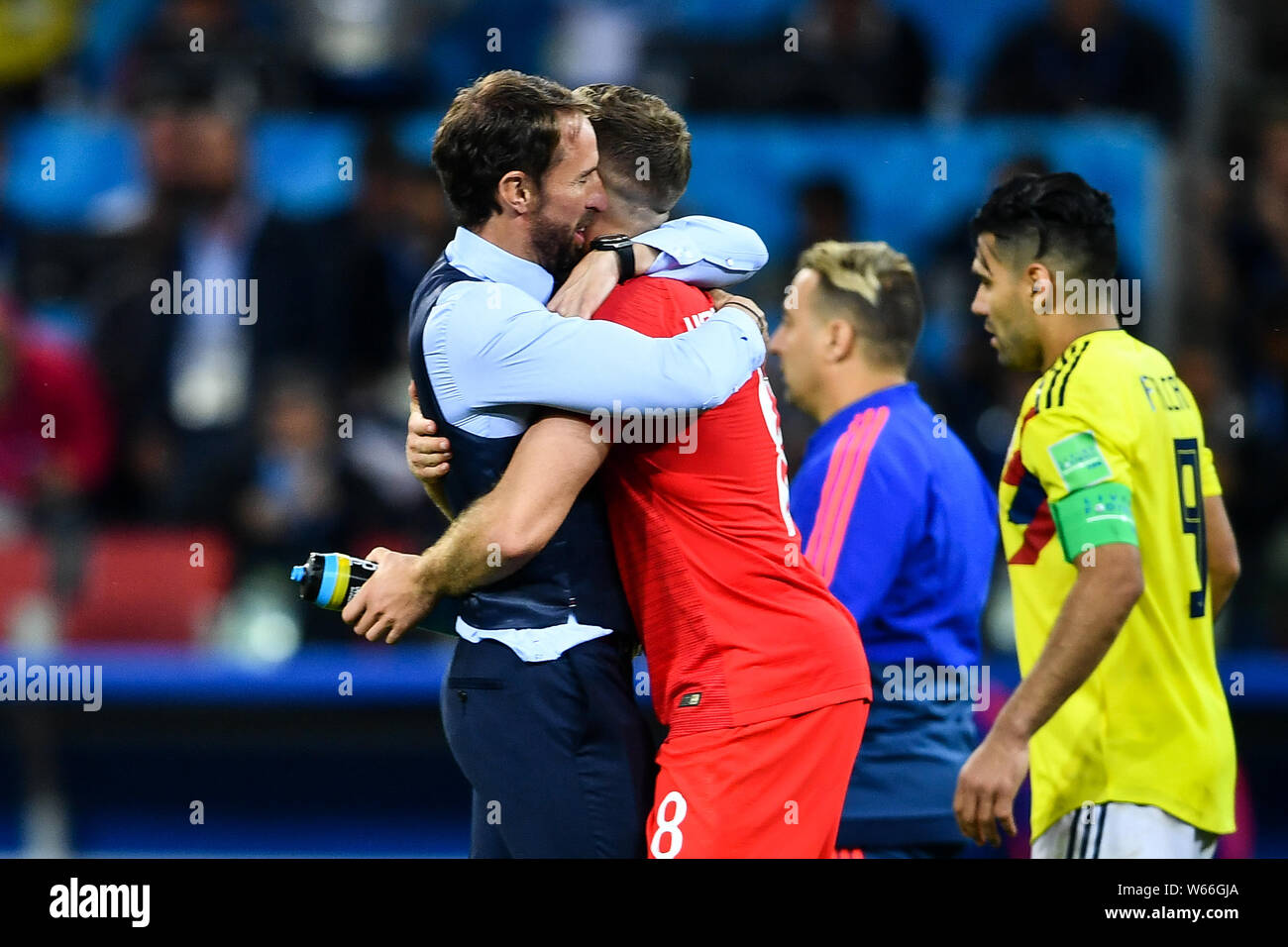 Jordan Henderson of England, right, celebrates with head coach Gareth Southgate after defeating Columbia in their Round of 16 match during the 2018 FI Stock Photo