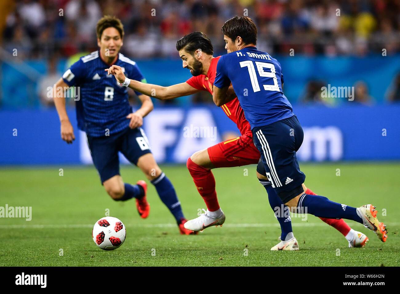 Yannick Carrasco of Belgium, center, challenges Genki Haraguchi and Hiroki Sakai of Japan in their Round of 16 match during the 2018 FIFA World Cup in Stock Photo
