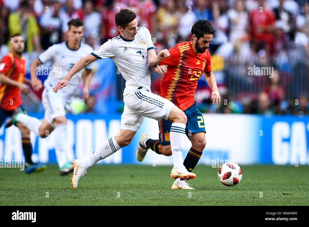 Daler Kuzyayev of Russia, left, challenges Isco of Spain in their Round of 16 match during the 2018 FIFA World Cup in Moscow, Russia, 1 July 2018.   R Stock Photo