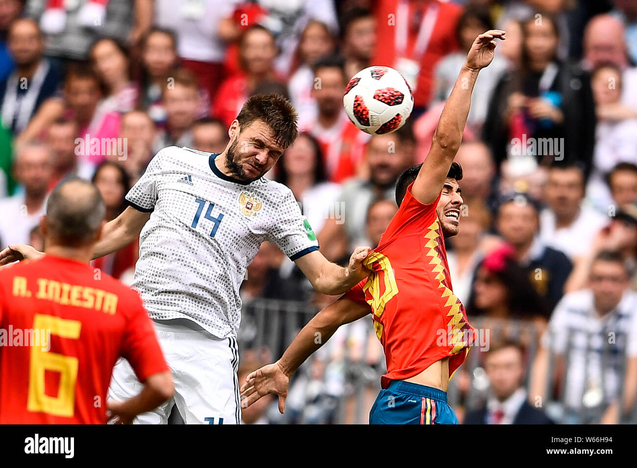 Vladimir Granat of Russia, left, heads the ball against a player of Spain in their Round of 16 match during the 2018 FIFA World Cup in Moscow, Russia, Stock Photo
