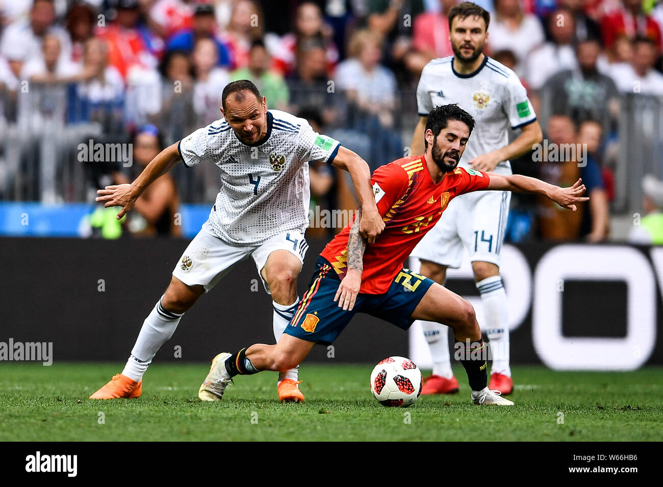 Sergei Ignashevich of Russia, left, challenges Isco of Spain in their Round of 16 match during the 2018 FIFA World Cup in Moscow, Russia, 1 July 2018. Stock Photo