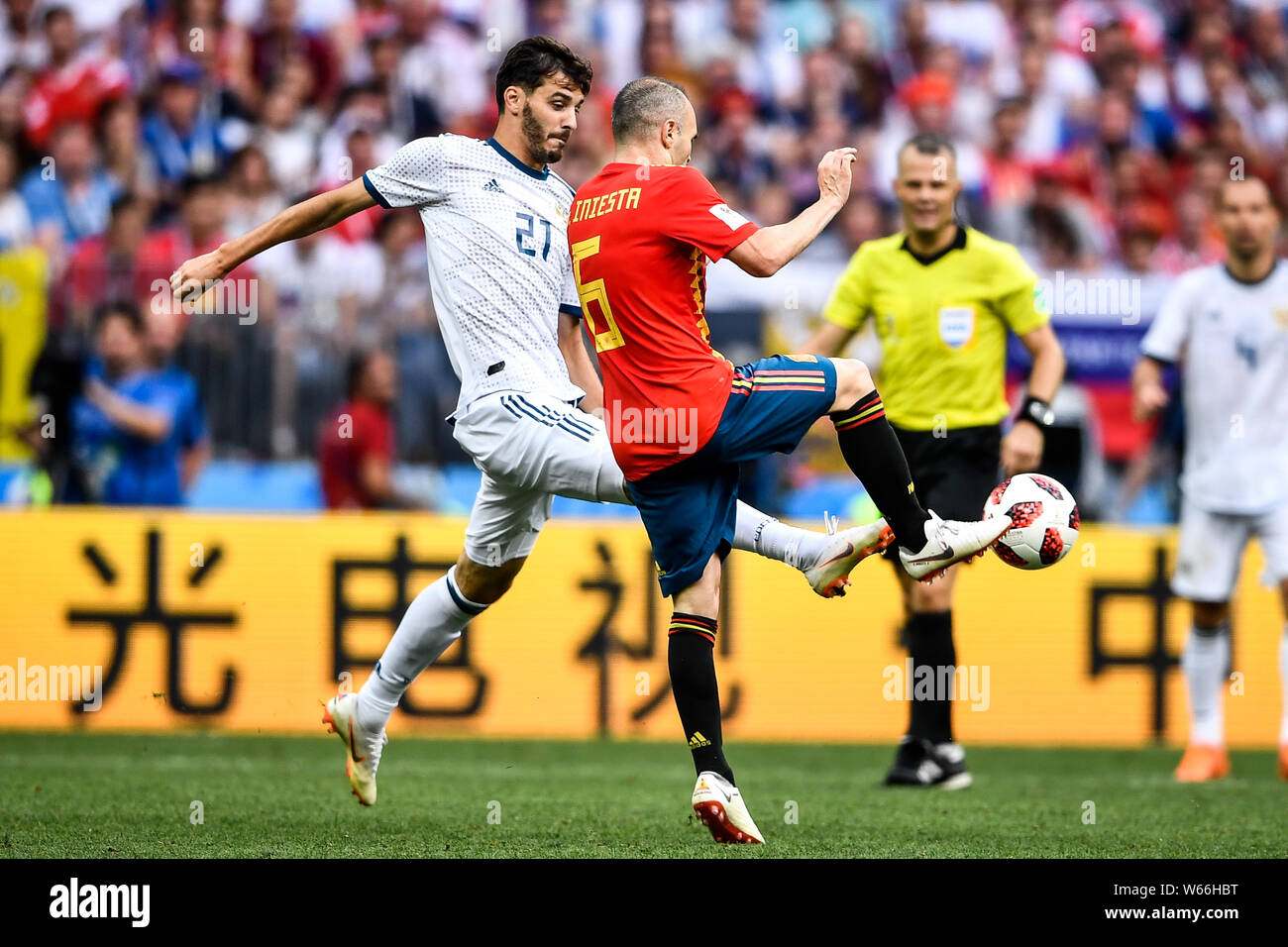 Aleksandr Yerokhin of Russia, left, challenges Andres Iniesta of Spain in their Round of 16 match during the 2018 FIFA World Cup in Moscow, Russia, 1 Stock Photo