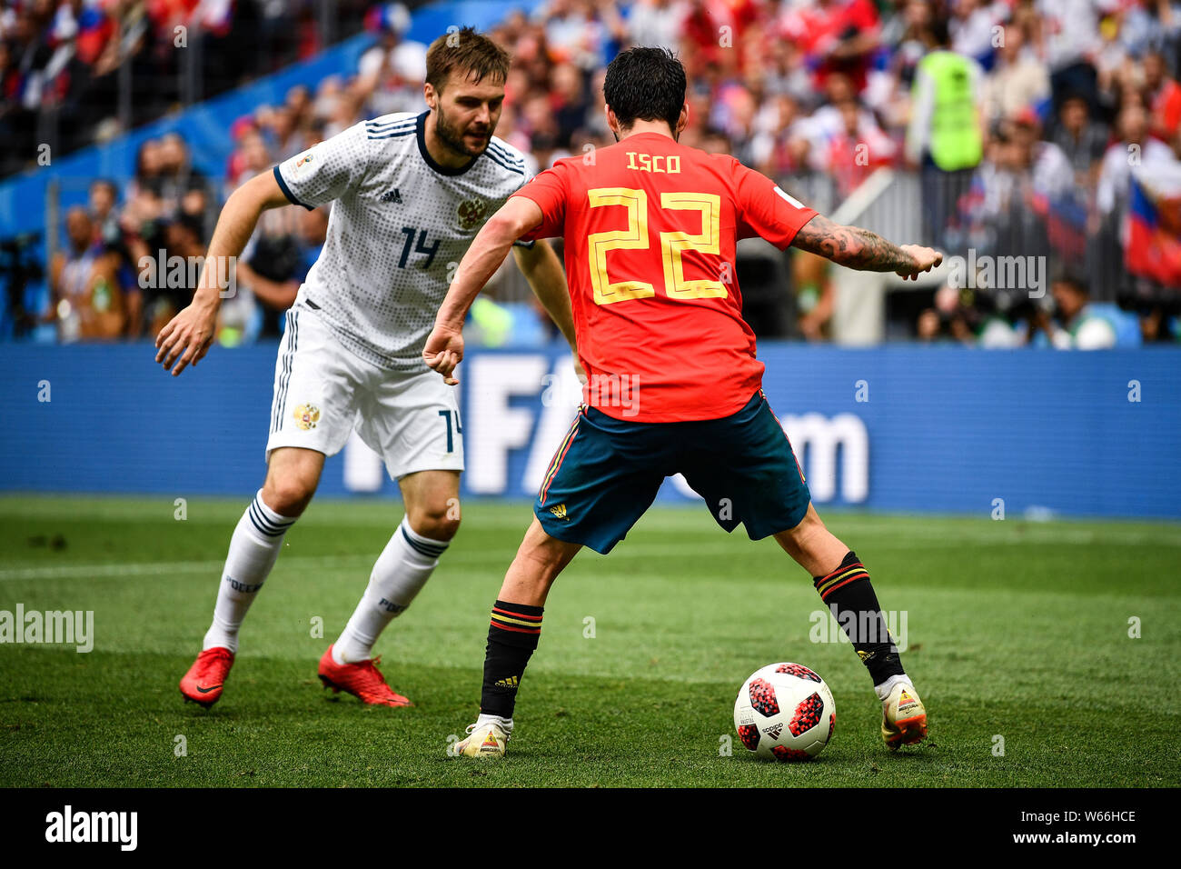 Vladimir Granat of Russia, left, challenges Isco of Spain in their Round of 16 match during the 2018 FIFA World Cup in Moscow, Russia, 1 July 2018. Stock Photo