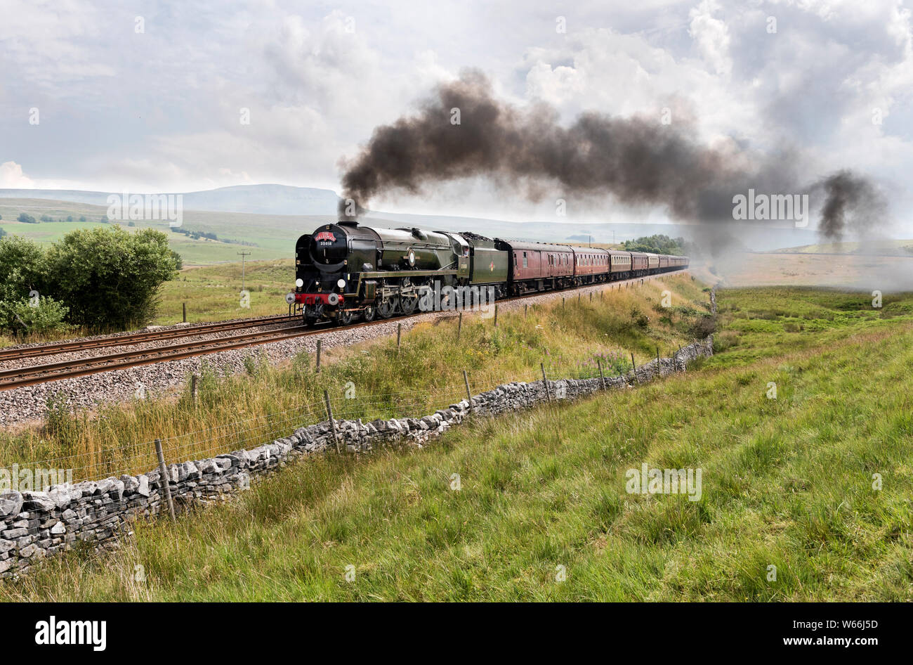 Steam locomotive 'British India Line' hauls 'The Dalesman' special train up the steep gradient towards Ribblehead on the Settle to Carlisle railway. Stock Photo