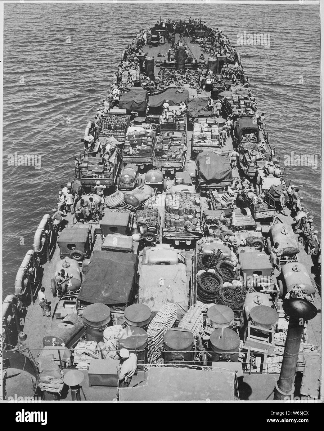 Invasion of Cape Gloucester, New Britain, 24 December 1943. Crammed with men and material for the invasion, this Coast Guard-manned LST nears the Japanese held shore. Troops shown in the picture are Marines.; General notes:  Use War and Conflict Number 855 when ordering a reproduction or requesting information about this image. Stock Photo