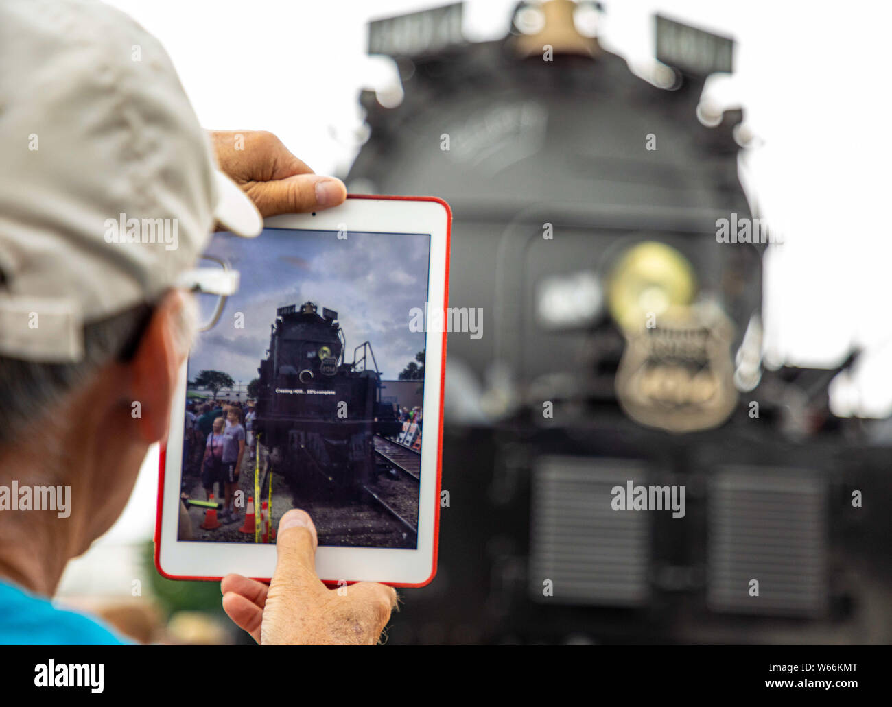 (190731) -- CHICAGO, July 31, 2019 (Xinhua) -- An enthusiast takes photos of the historic Big Boy No. 4014 steam locomotive in West Chicago, Illinois, the United States, on July 29, 2019. The Big Boy No. 4014 steam locomotive spent three days in West Chicago during a tour to commemorate the 150th anniversary of the completion of the transcontinental railroad. (Photo by Joel Lerner/Xinhua) Stock Photo