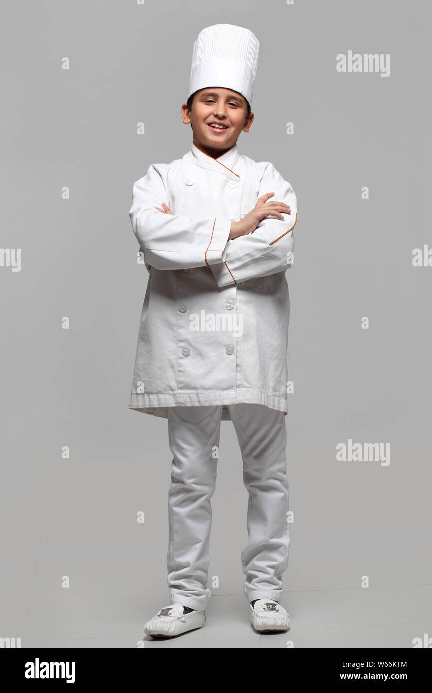 Boy pretending to be a chef and smiling Stock Photo