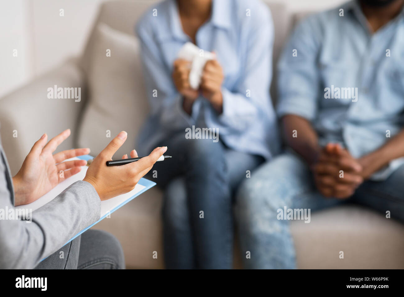 Psychologist counselling young african american married couple Stock Photo