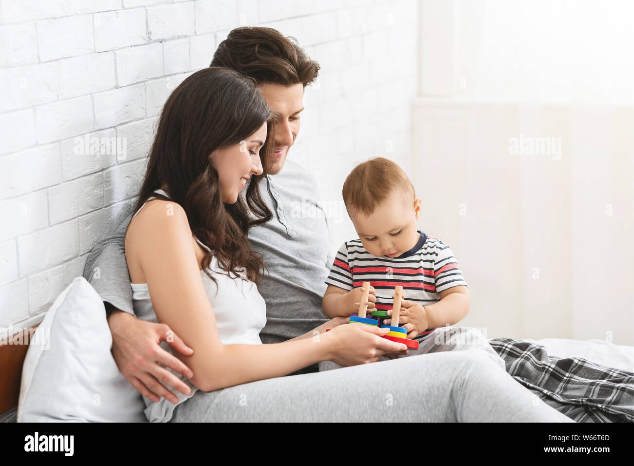 Cute baby playing developing games with parents Stock Photo