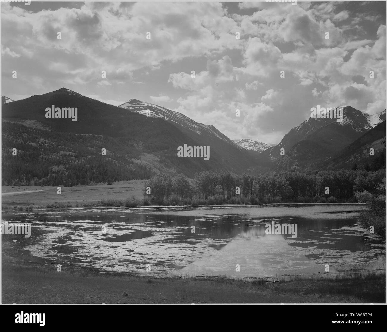Lake and trees in foreground, mountains and clouds in background, In Rocky Mountain National Park,Colorado., 1933 - 1942 Stock Photo