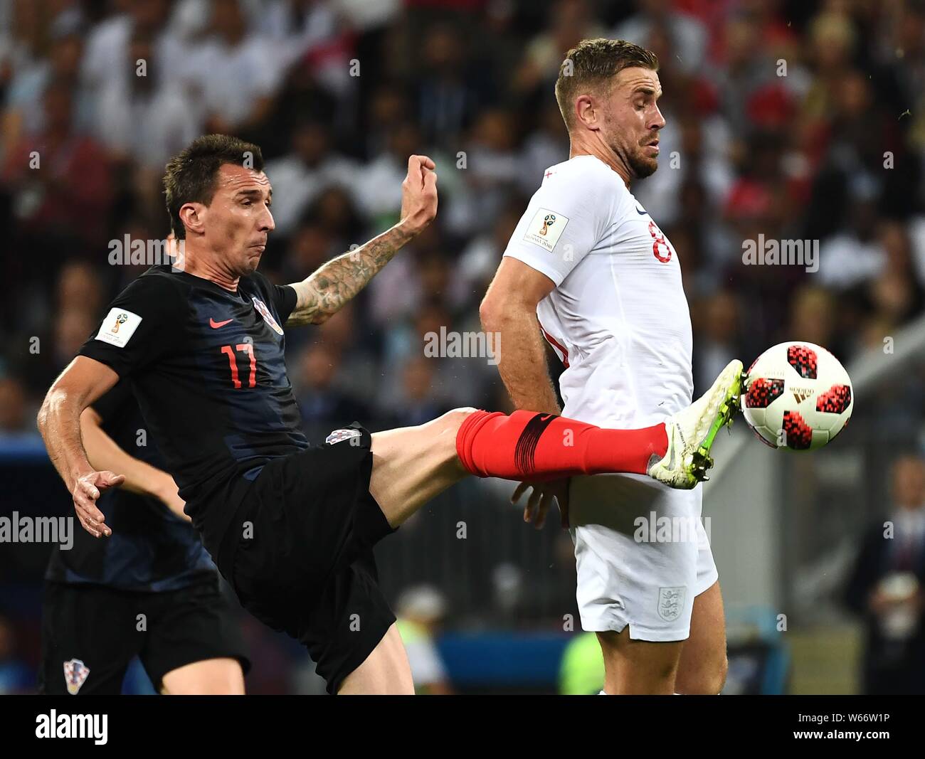Mario Mandzukic of Croatia, left, challenges Jordan Henderson of England in their semifinal match during the 2018 FIFA World Cup in Moscow, Russia, 11 Stock Photo