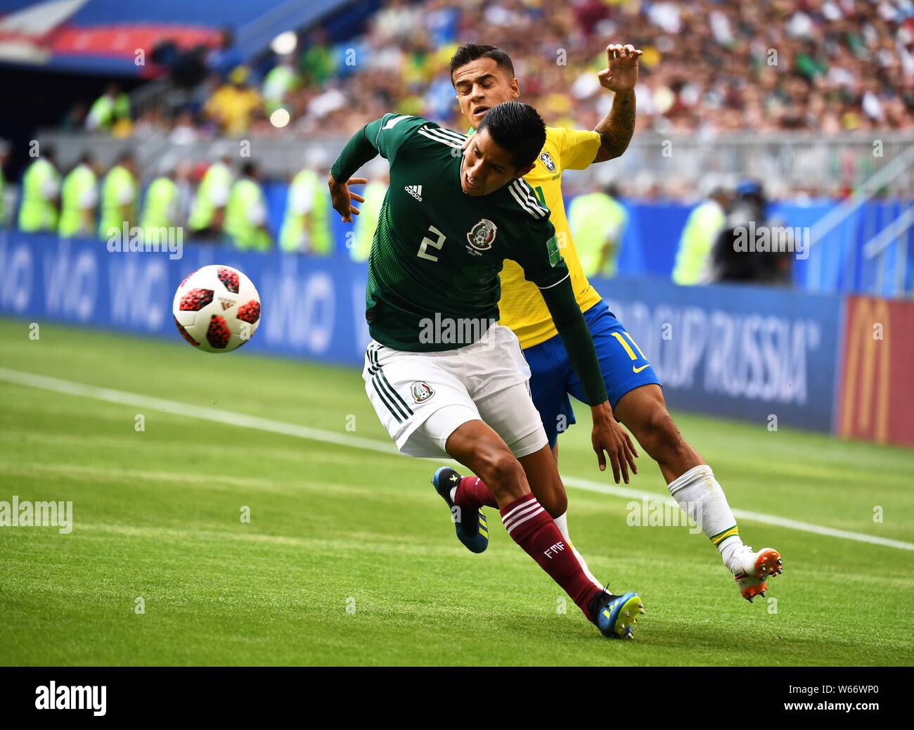 Philippe Coutinho of Brazil, back, challenges Hugo Ayala of Mexico in their Round of 16 match during the 2018 FIFA World Cup in Samara, Russia, 2 July Stock Photo
