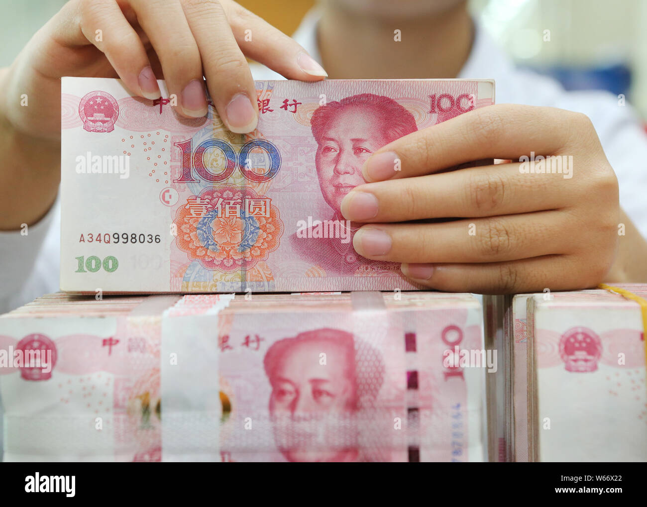 Counting Rmb A Chinese clerk counts RMB (renminbi) yuan banknotes at a bank in ...