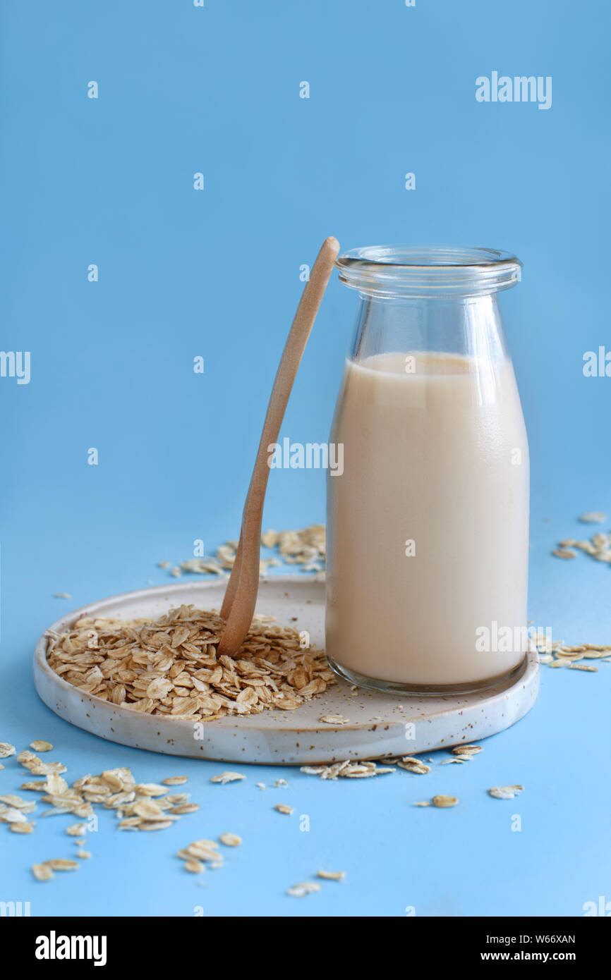 Vegan oat milk, non dairy alternative milk on a light blue background Stock Photo