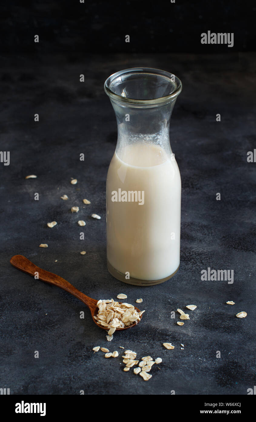 Vegan oat milk, non dairy alternative milk in a small bottle close up