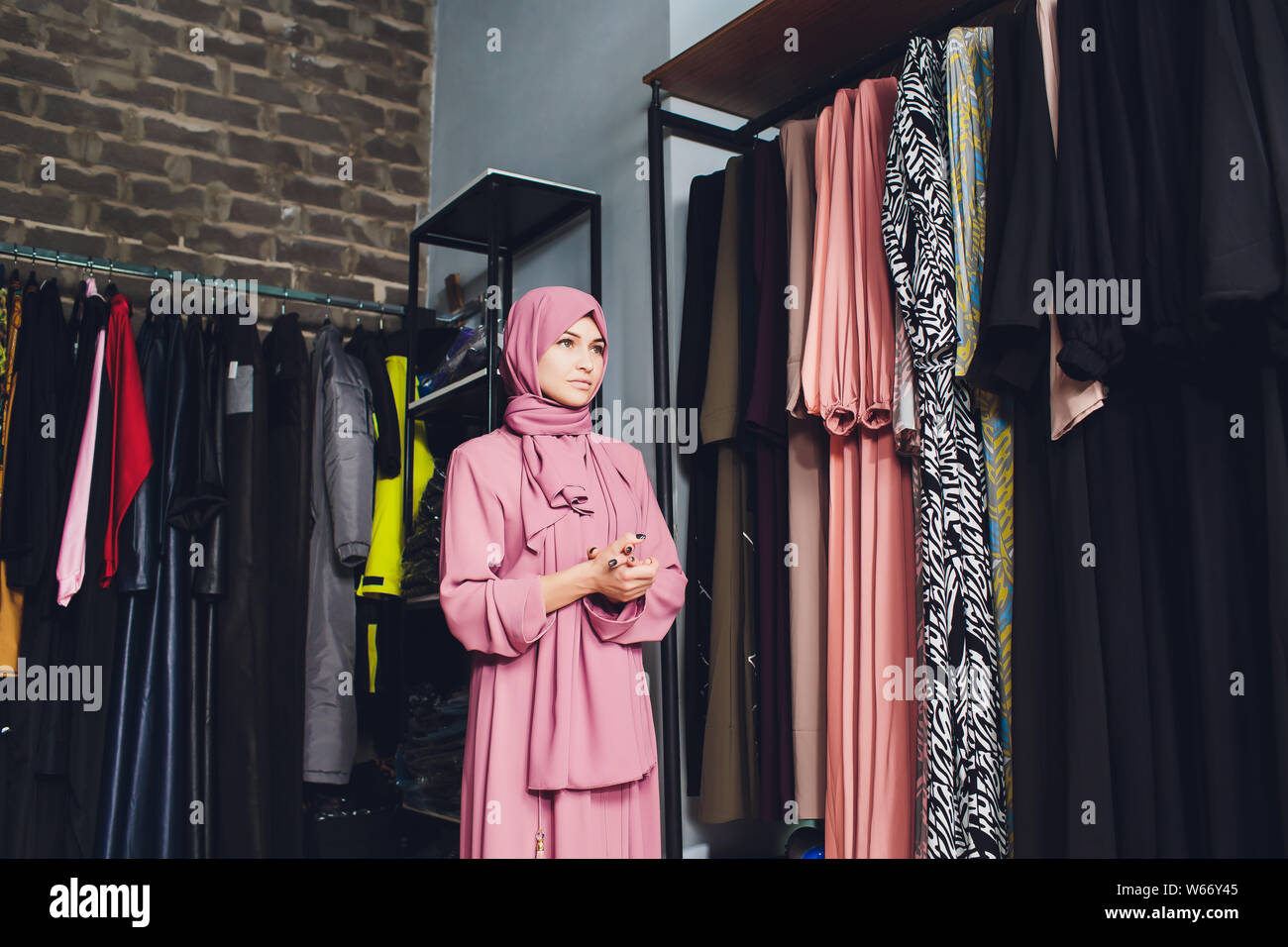 Arab woman in traditional Muslim clothes buys a new dress in an Oriental store Stock Photo Alamy