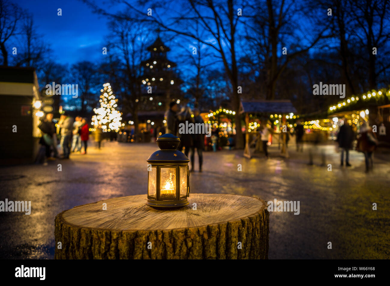 Lantern on a tree stump at christmas fair at Chinese tower, Munich, Germany Stock Photo