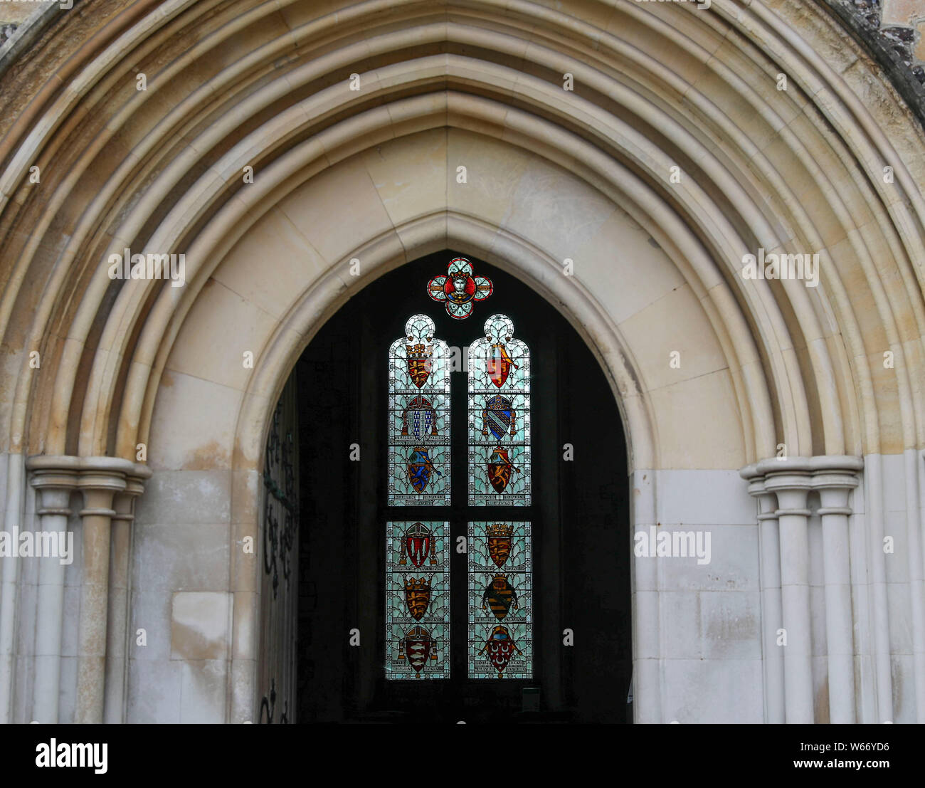 A stained glass window is seen through the entrance to the Great Hall ...