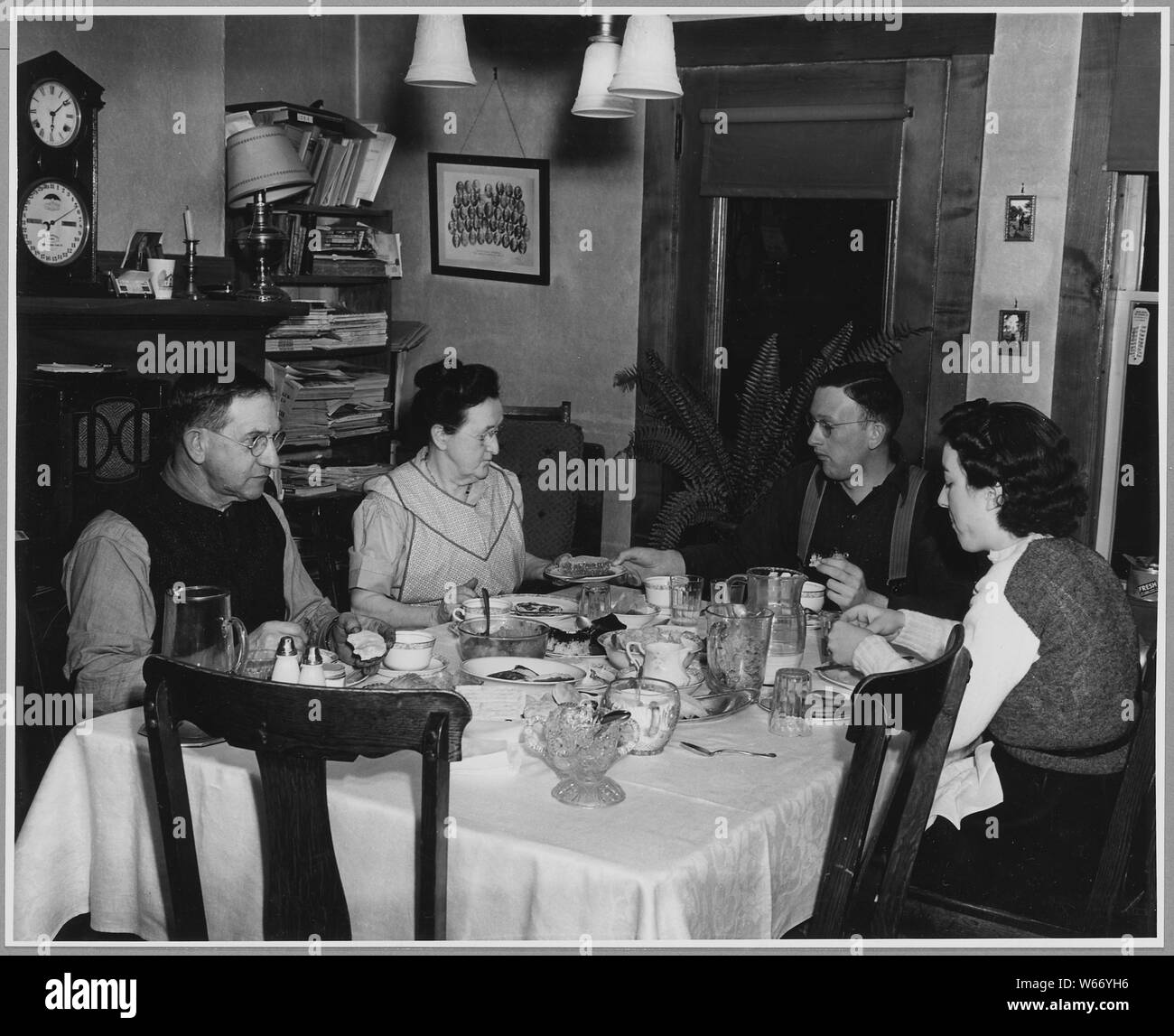 Landaff, Grafton County, New Hampshire. The Chandlers, father, mother, and son, and the school teach . . .; Scope and content: Full caption reads as follows: Landaff, Grafton County, New Hampshire. The Chandlers, father, mother, and son, and the school teacher who boards with them have a light supper without hot food. Dinner is at noon at which time, meat, potatoes, vegetables, bread, butter, relish, pies, and milk are served. Very little of the food eaten in this house comes out of cans. Stock Photo