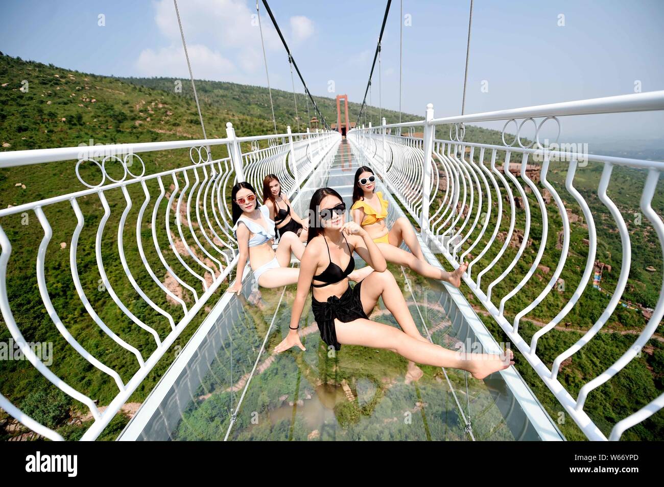 Chinese beauties in bikini pose on the 5D glass bridge at the Wan An Shan  Grand Canyon in Luoyang city, central China's Henan province, 21 July 2018  Stock Photo - Alamy