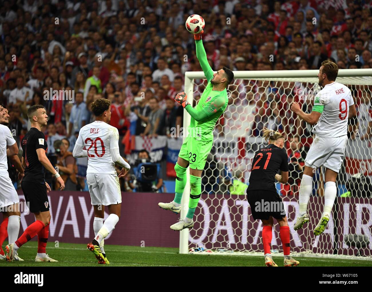 Goalkeeper Danijel Subasic of Croatia, center, jumps to hit the ball in their semifinal match against England during the 2018 FIFA World Cup in Moscow Stock Photo