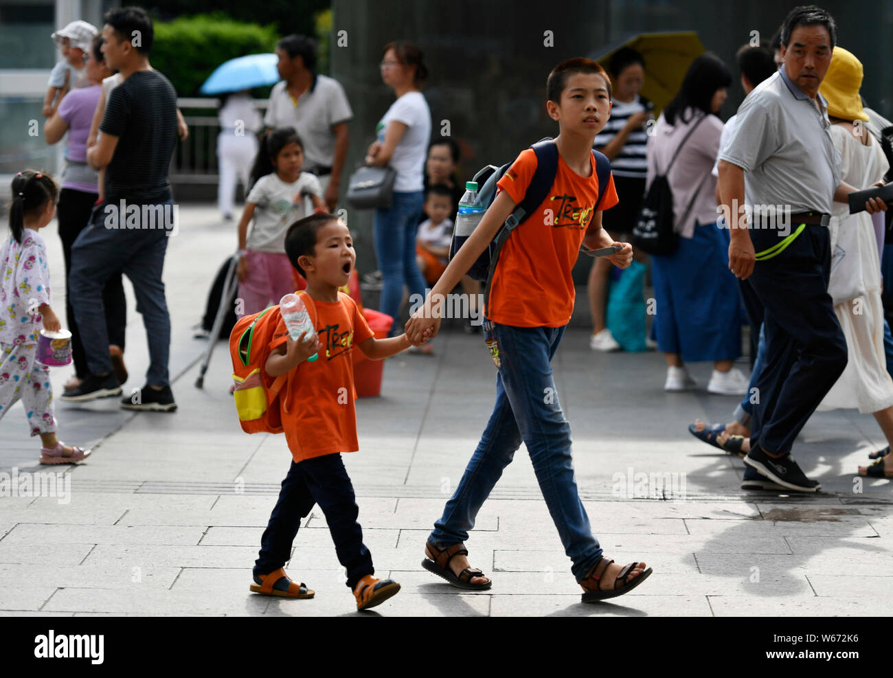 Young Chinese children carry luggages as they are going on their way to ...