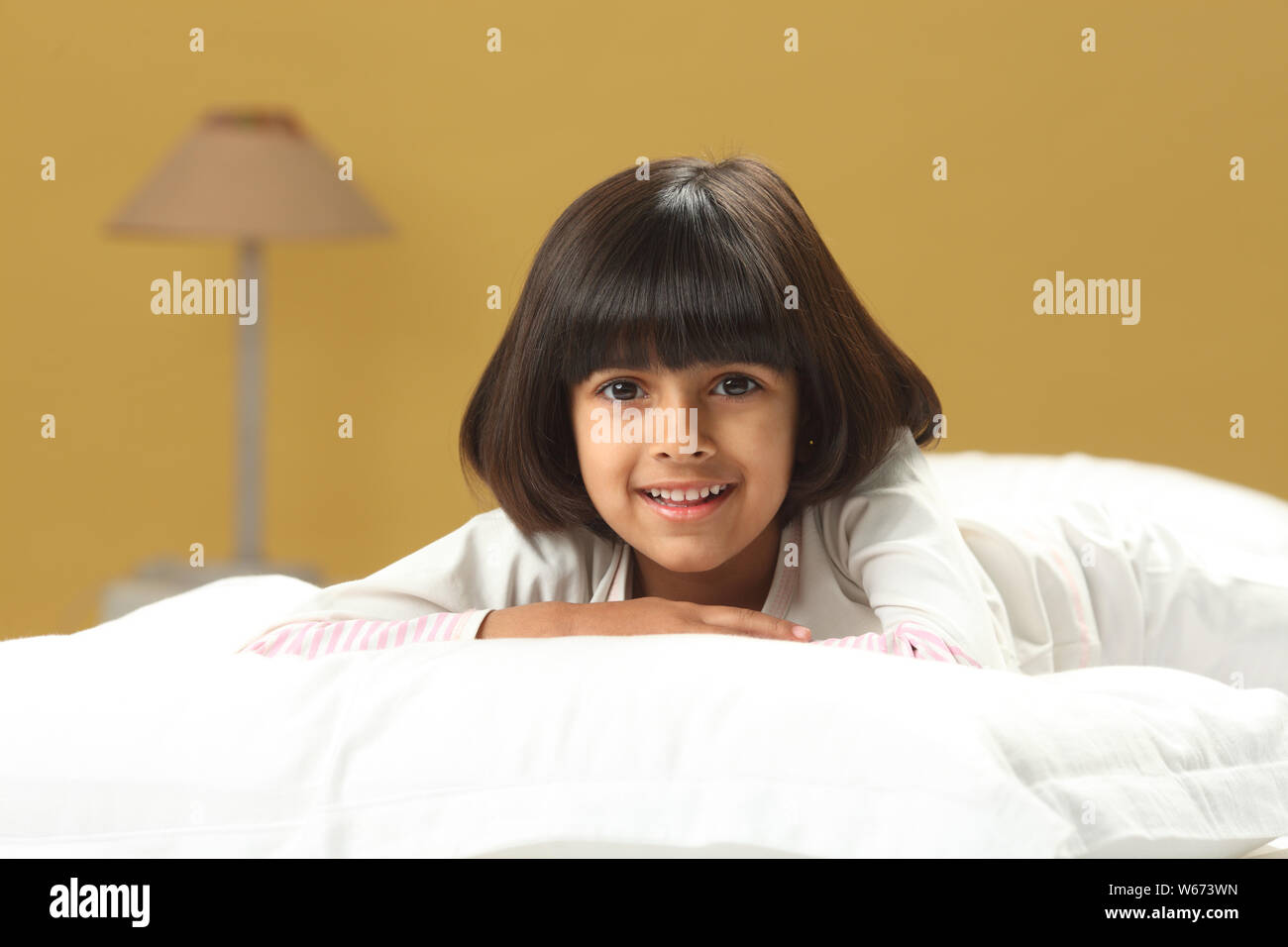 Girl lying on the bed and smiling Stock Photo - Alamy