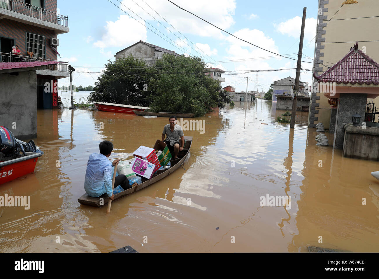 Chinese rescuers carry rescue relief to local residents trapped by floodwater caused by torrential rain in Qiaoxi village, Dongxiang district, Fuzhou Stock Photo