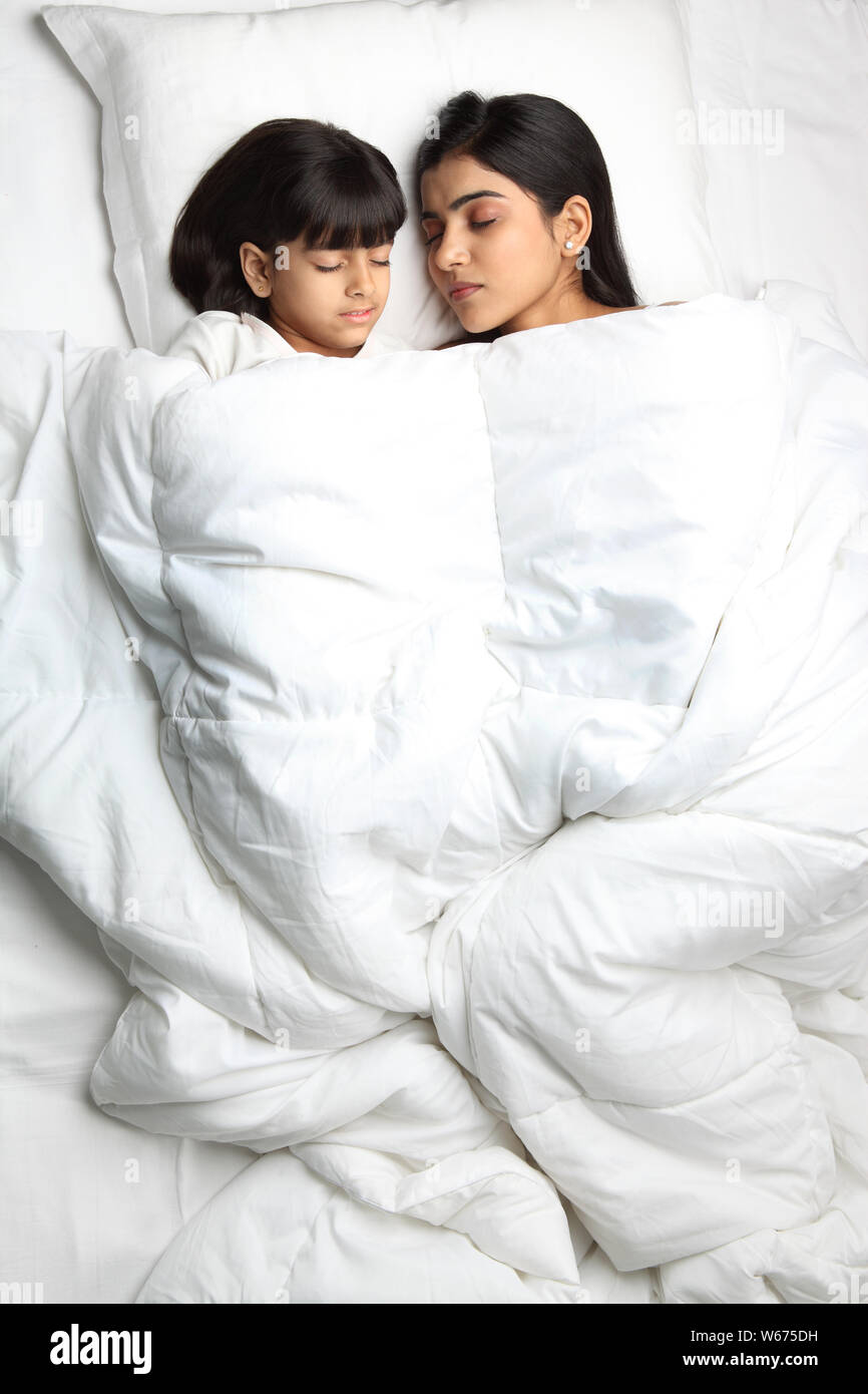 Mother with daughter sleeping in the bed Stock Photo pic