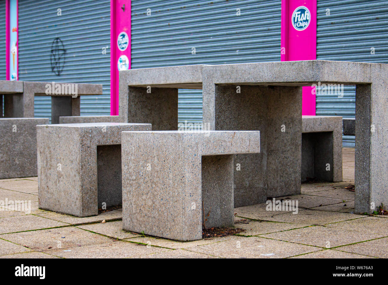 Concrete furniture outside a fish and chip shop in Gravesend pier, Kent