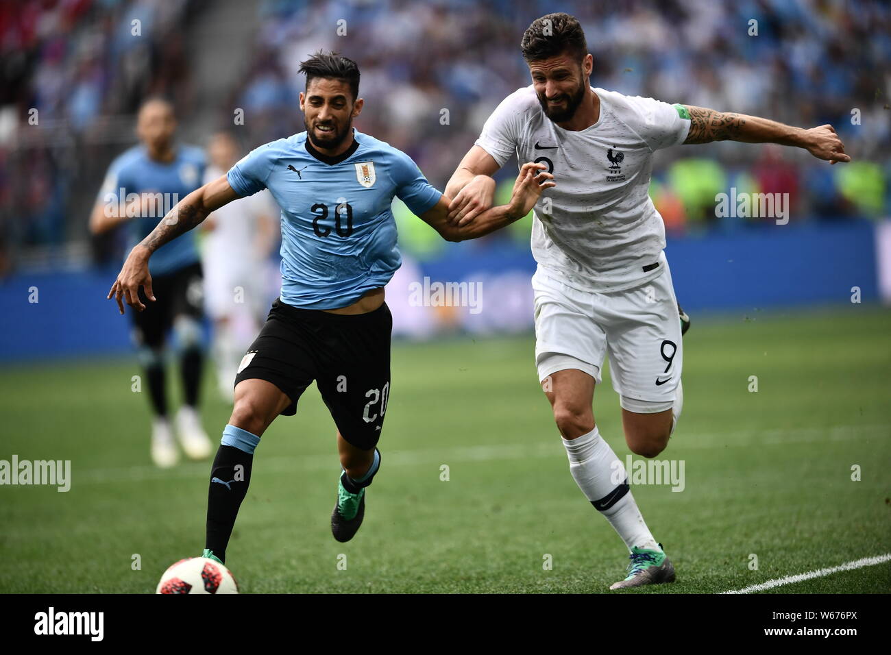Jonathan Urretaviscaya, left, of Uruguay passes the ball against Olivier Giroud of France in their quarterfinal match during the 2018 FIFA World Cup i Stock Photo