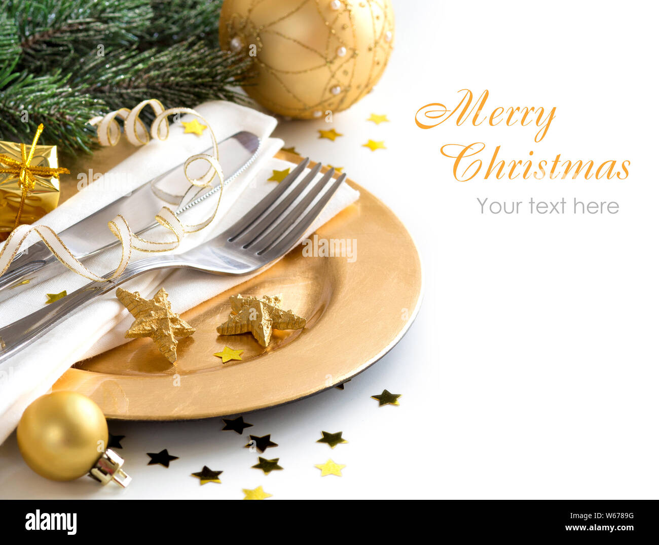 Festive table setting with golden bauble and plate Stock Photo - Alamy