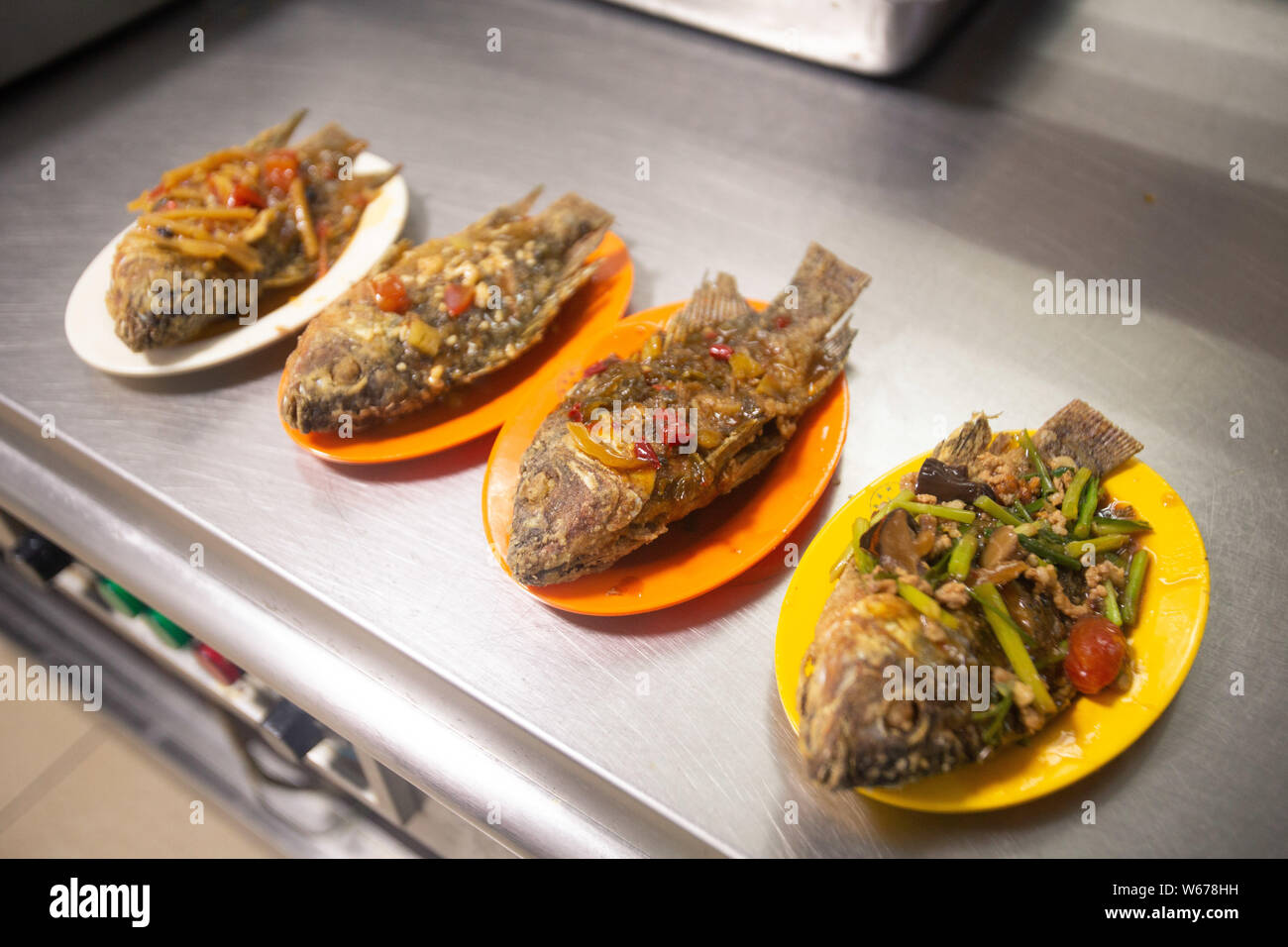 Fish dishes in different flavors, which are harvested from the Xinghu Lake in the campus of Guangxi Medical University, are served to teachers and stu Stock Photo