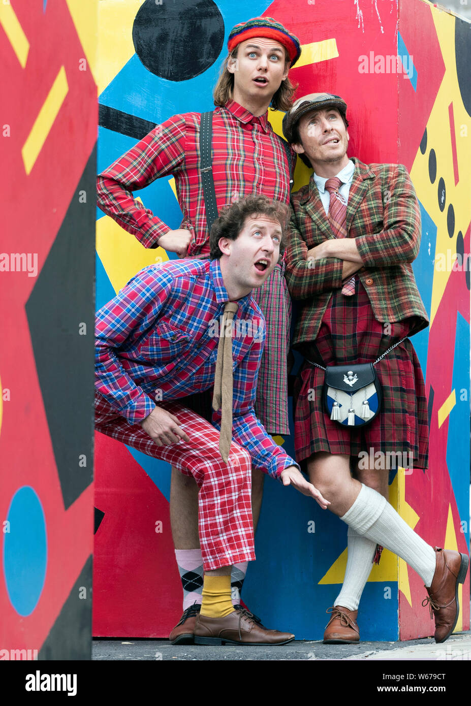 Performers (left to right) Jonathan Tilley, Oliver Nilsson and Sam Dugmore from the award-winning international comedy trio The Latebloomers pay tribute to all things truly Scottish in tartan costumes ahead of their Edinburgh Festival Fringe debut show 'Scotland!' at the Assembly Rooms, Edinburgh. Stock Photo