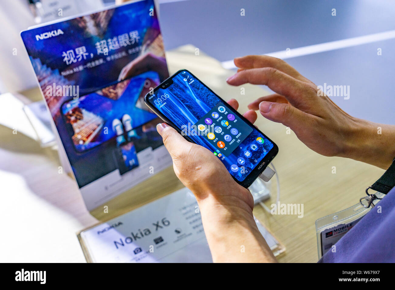 --FILE--A visitor tries out a Nokia X6 during the 2018 Mobile World Congress (MWC) in Shanghai, China, 29 June 2018.   Nokia Oyj and China Mobile Ltd. Stock Photo