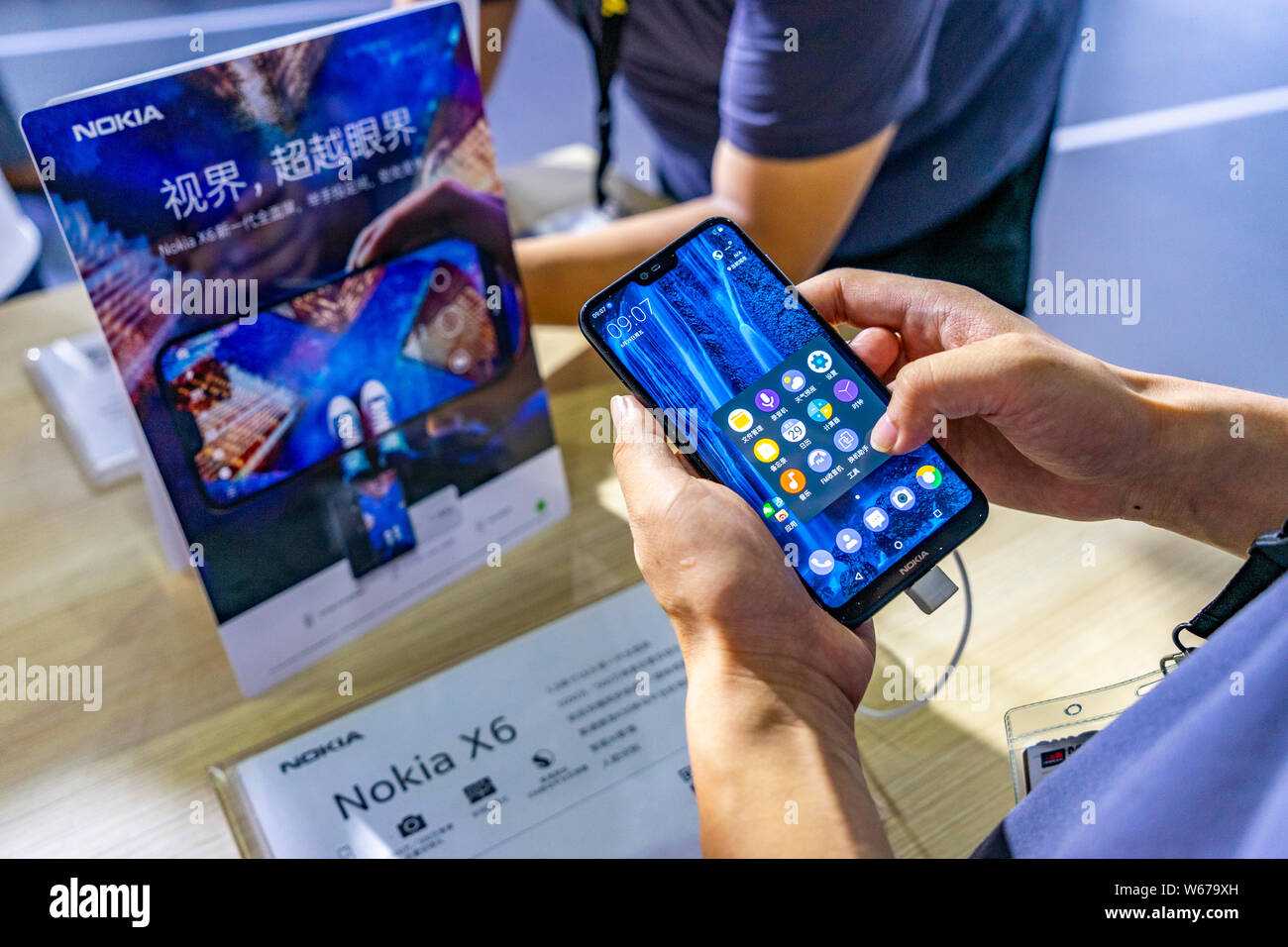 --FILE--A visitor tries out a Nokia X6 during the 2018 Mobile World Congress (MWC) in Shanghai, China, 29 June 2018.   Nokia's operating profit declin Stock Photo