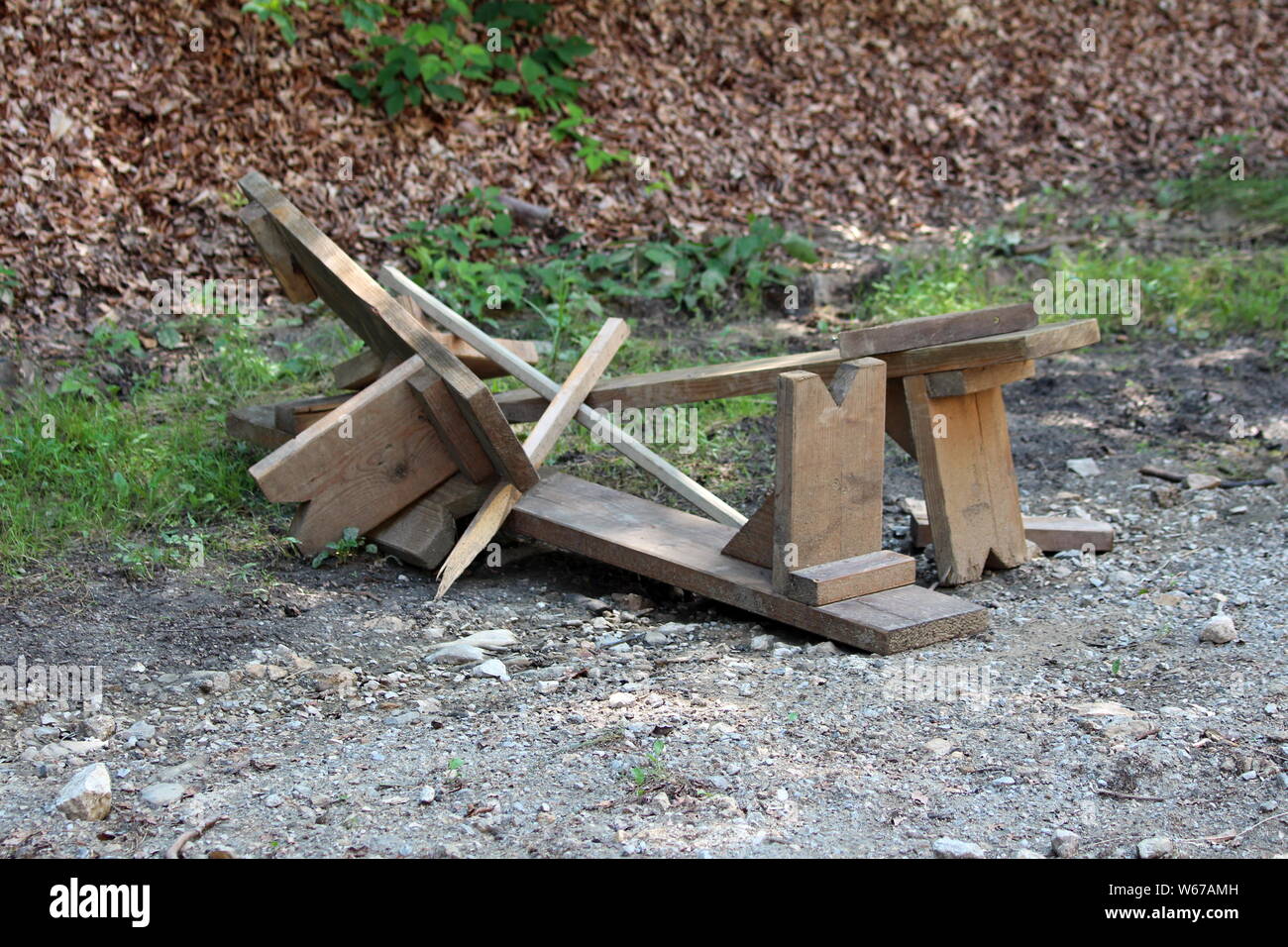 Broken Homemade Wooden Benches Left On Gravel Road In Local Forest
