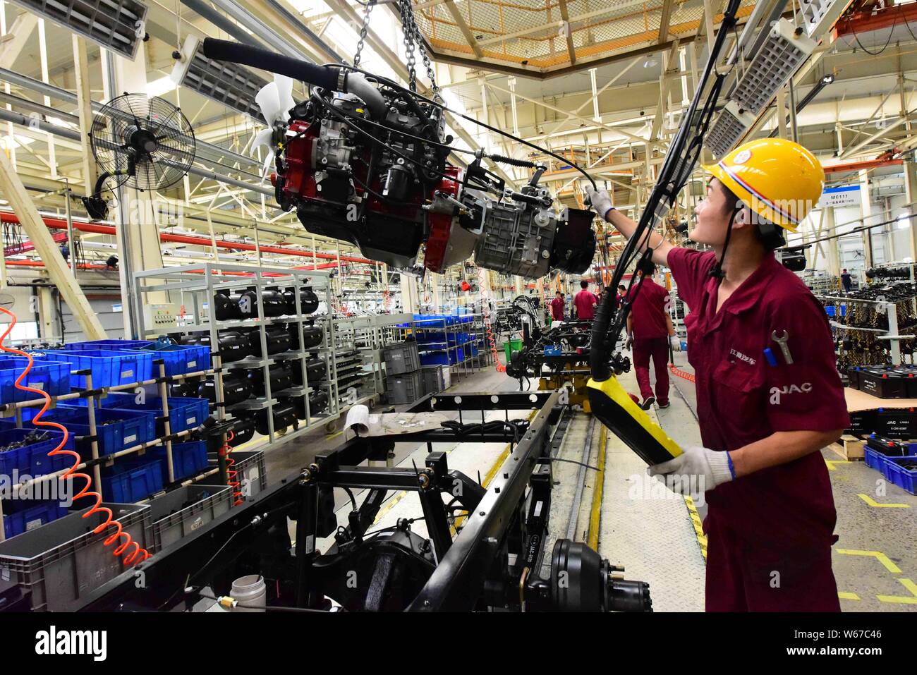 --FILE--A Chinese worker assembles a car on the assembly line at the ...
