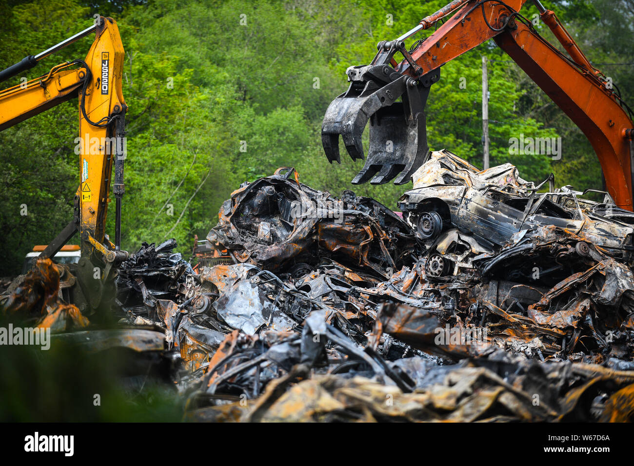 Piles of burnt cars are pictured at a scrap yard in Ammanford, Wales, UK after a fire, leaving
