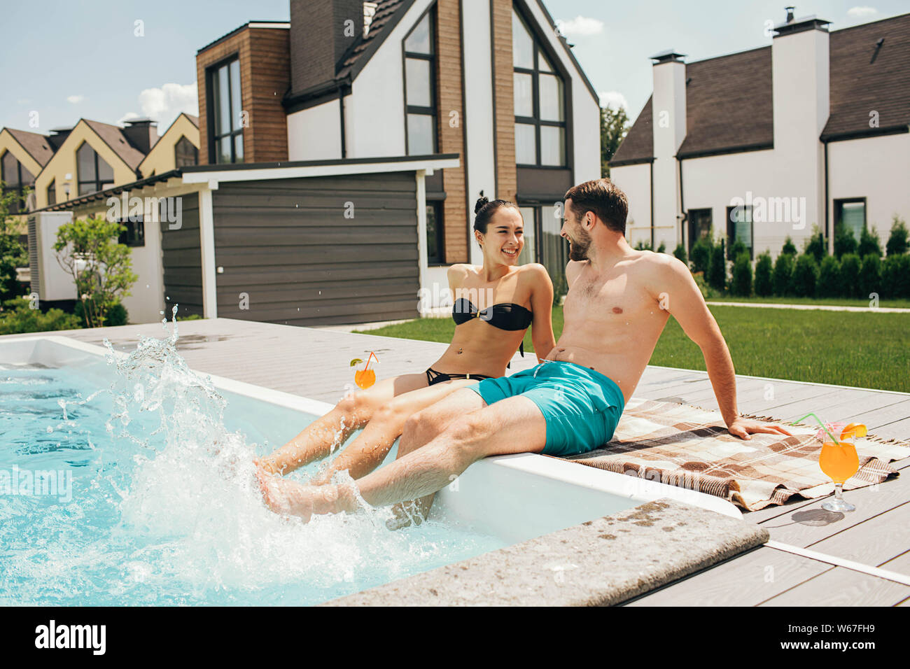 man and a woman look lovingly at each other while in the pool. Goodbye work, hi summer vacation-swimming and tanning Stock Photo