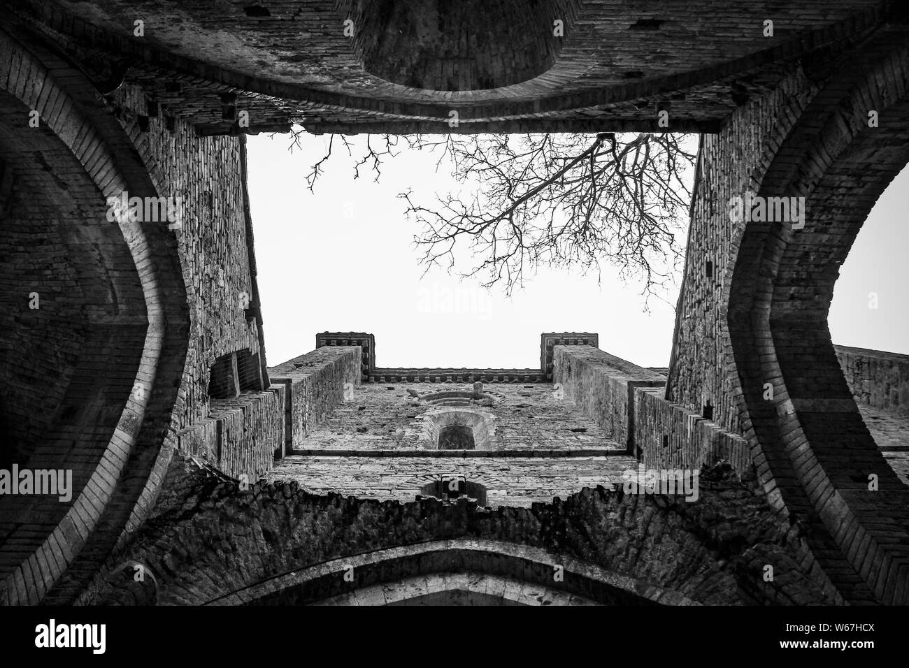 Low angle shot of arched type doorways in black and white at Abbazia di San Galgano Stock Photo
