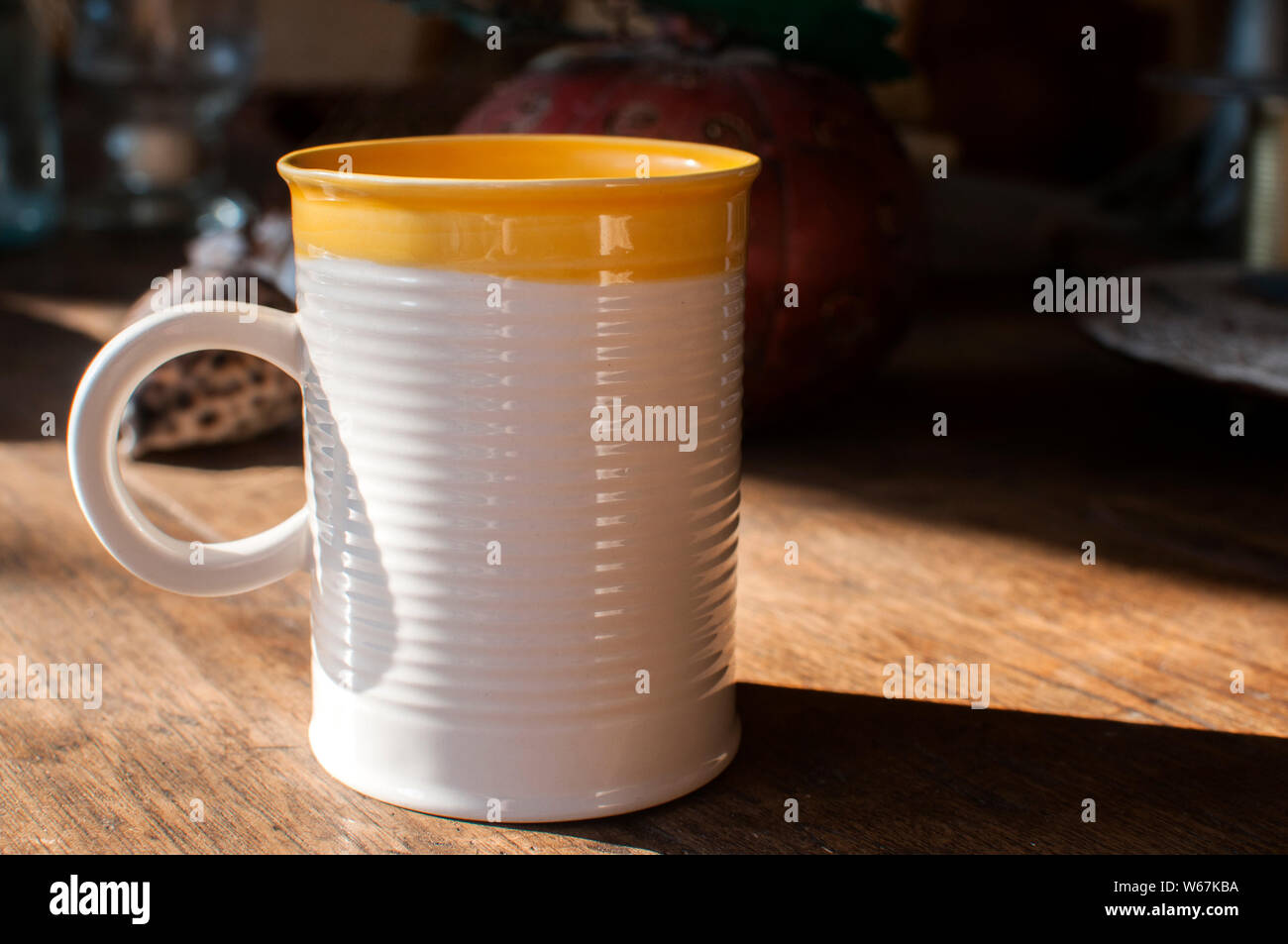 Ceramic tea mug closeup on wooden board surface Stock Photo