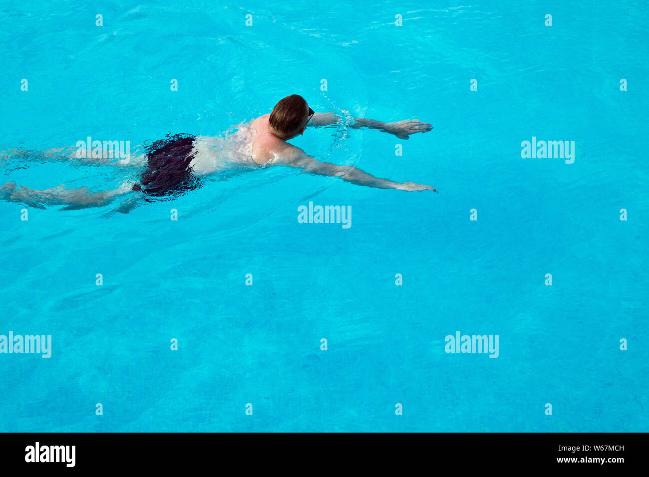 man in swimming pool wearing sunglasses Stock Photo