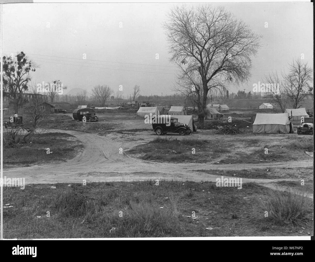 Olivehurst, 2 miles south of Marysville, Yuba County, California. Squatter Community of 52 camps, a . . .; Scope and content:  Full caption reads as follows: Olivehurst, 2 miles south of Marysville, Yuba County, California. Squatter Community of 52 camps, agricultural worker families on bank of river, outskirts of Marysville.... There is almost no work in this area at this season of the year. No sanitation, culinary water from river. Stock Photo