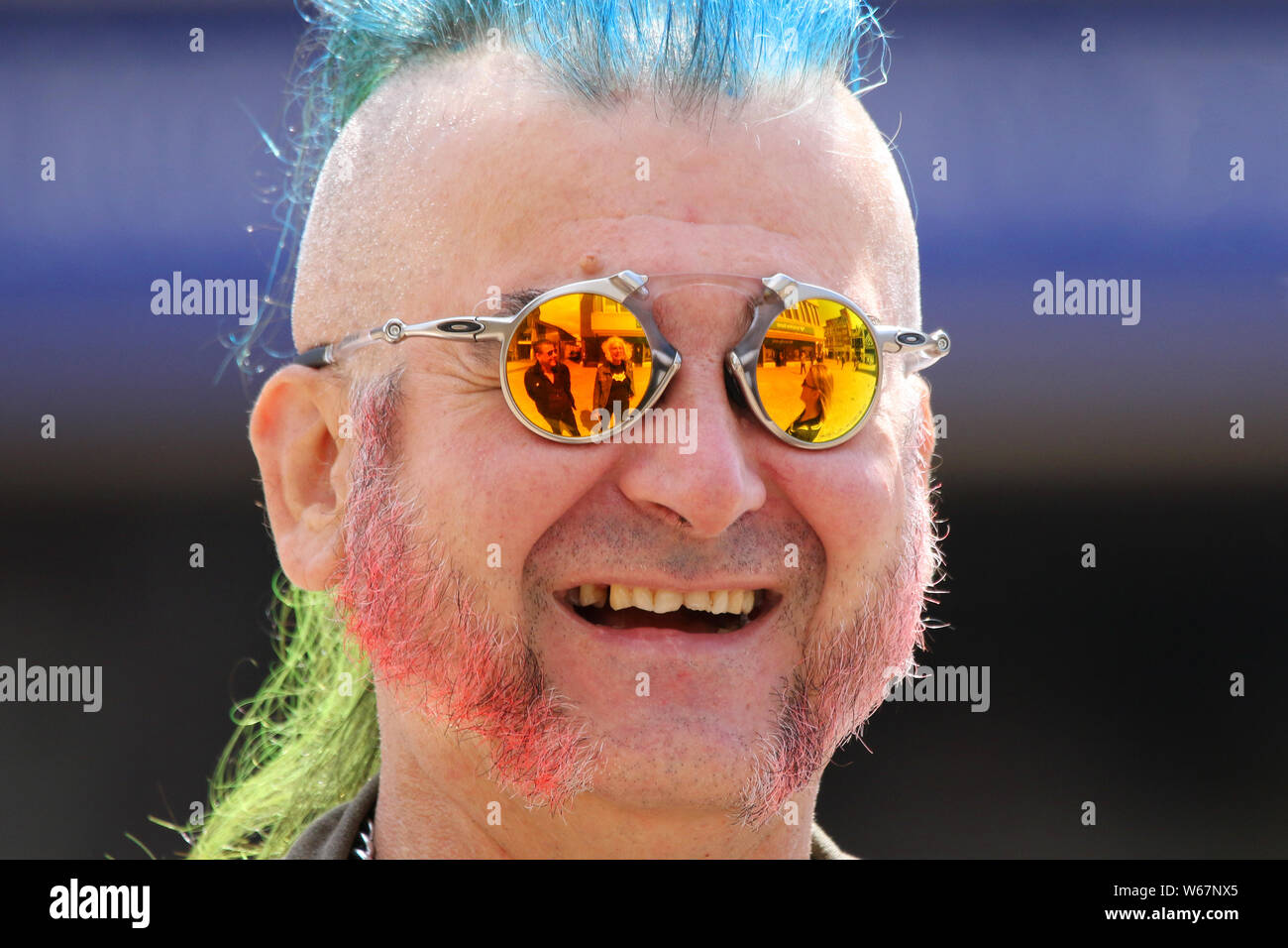 Elderly punk rocker with reflective sunglasses in Blackpool, Lancashire, UK. 31st July, 2019. The fabulous Punk Rebellion festival returns to the Winter Gardens in Blackpool for a weekend of live punk rock music. The Rebellion Festival, formerly Holidays in the Sun and the Wasted Festival is a British punk rock festival first held in 1996. This open to all event draws thousands of overseas visitors to see all their favourite punk musicians in one place. Stock Photo